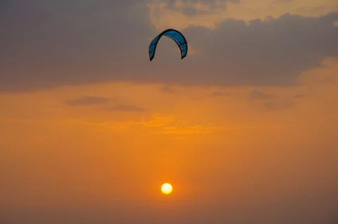 Kite surfing at sunset Stock Photos