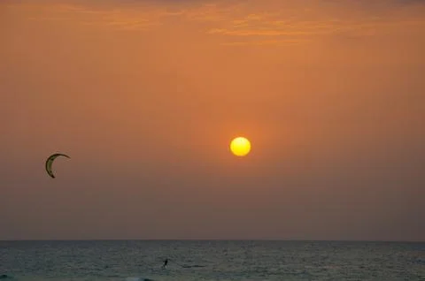 Kite surfing at sunset Stock Photos