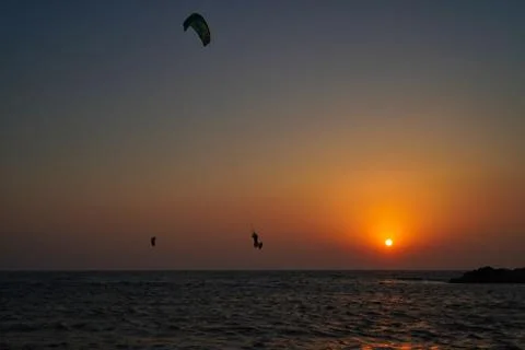 Kite surfing at sunset Stock Photos