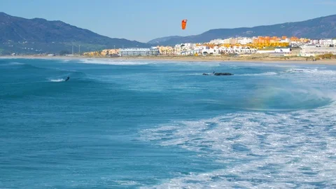 The kite-surfing surfer sails on the ocean wave. Spain. Tarifa. Vídeo Stock 124010433