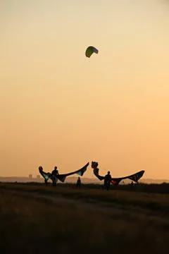 Kite surfing while sunset Stock Photos