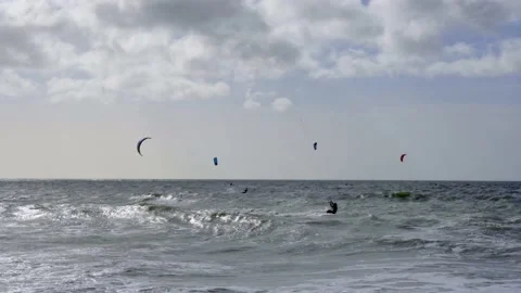 Kite surfing on windy day in rough sea on Southbourne Beach, Dorset Stock Footage 238528296