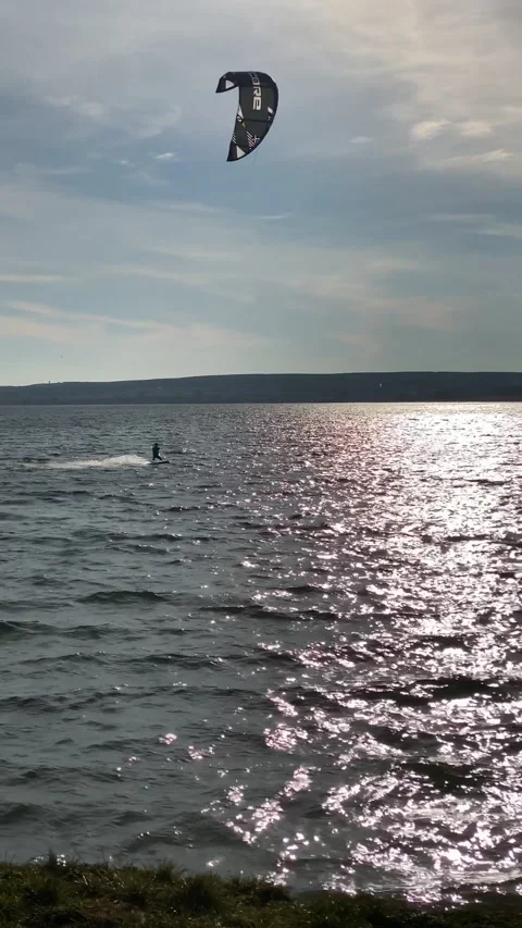 Kiteboarder ketch the wind on sunset Stock Footage 238976342