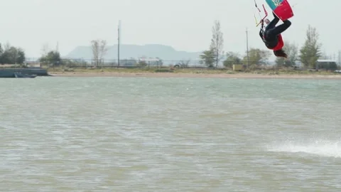 Kiteboarder rides on a kite doing and practicing tricks in sea bay. Freestyle Stock Footage 219602933