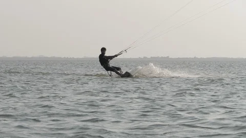 Kiteboarder struggles controlling kite lines slow motion Stock Footage 118991724