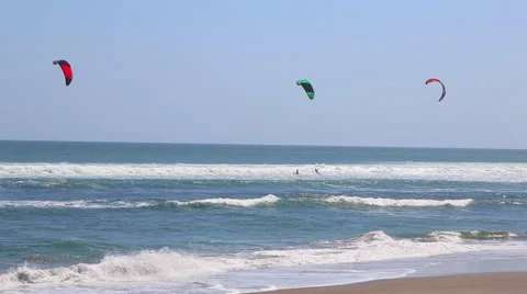 Kiteboarder's enjoying surfing in the sea Stock Footage