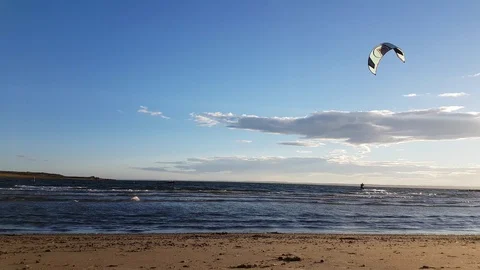 Kiteborder is crossing beach from right to left in Larkollen, Norway Stock Footage 87139440