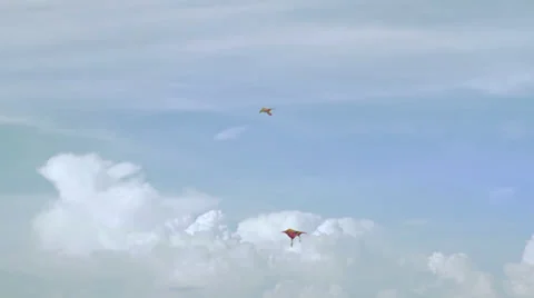 Kites fly in the sky with puffy clouds in background Stock Footage 37827138