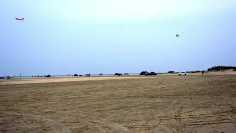 Kites Flying over Wide Sandy Beach with Cars, Southern Denmark Stock Footage 333897180