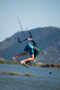 Kitesurfer athlete doing double backroll on air Stock Photos