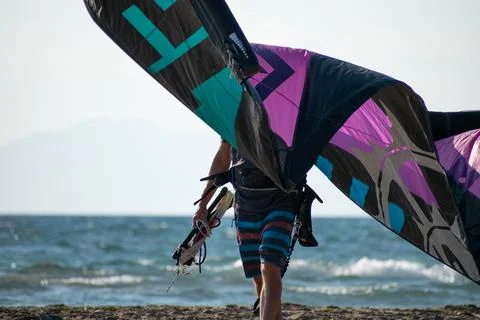 Kitesurfer athlete doing double backroll on air Stock Photos