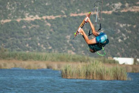 Kitesurfer athlete doing double backroll on air 写真素材