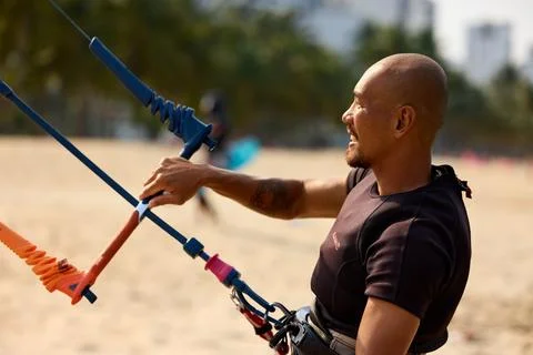 Kitesurfer controls his kite from the beach after a session in Nha Trang, V.. Stock Photos