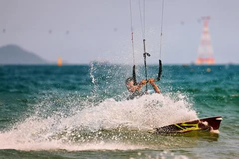 Kitesurfer Cutting Through Waves in Open Sea Photos