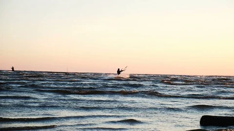 Kitesurfer does a trick with a board on the sea at sunset in summer, slow motion Stock Footage 90556876