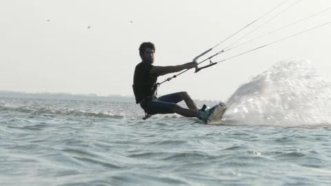 Kitesurfer moves forward camera riding on edge close view Stock Footage 118992237