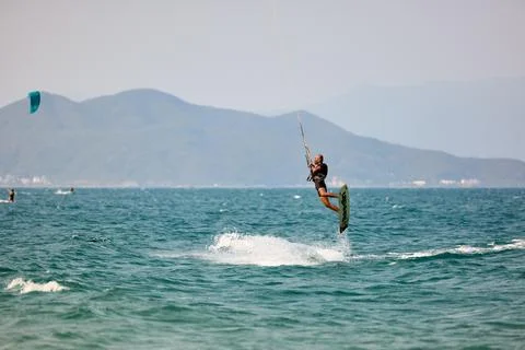 Kitesurfer performs a high Big Air jump over the sea in Nha Trang, Vietnam Stock Photos