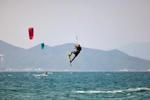 Kitesurfer performs a high Big Air jump over the sea in Nha Trang, Vietnam Stock Photos