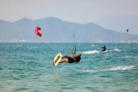 Kitesurfer performs low jump above waves in Nha Trang Vietnam Stock Photos