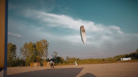 Kitesurfer practicing with kite on land, training for water sports. Slow motion Video stock 292868840