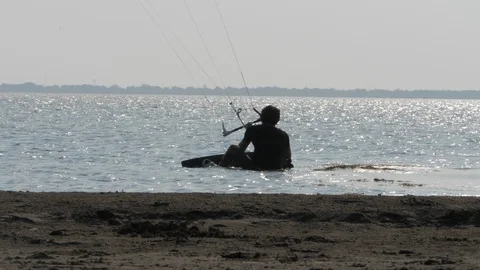 Kitesurfer rides passing skillful guy on board slow motion Stock Footage 118993568