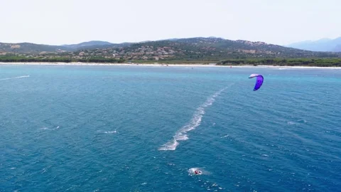 Kitesurfer Riding On Blue Ocean Waves With A Kite Overhead. - aerial shot Stock Footage 344036993