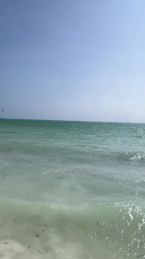 Kitesurfer riding turquoise ocean waves kiteboarding Paje Zanzibar HD vertical Stock-Footage 342170544