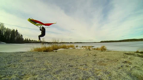 Kitewing skier jumping over a rock in slow motion Stock Footage 36426892