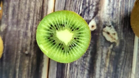 Kiwi and half on a wooden table Stock Footage 227721790