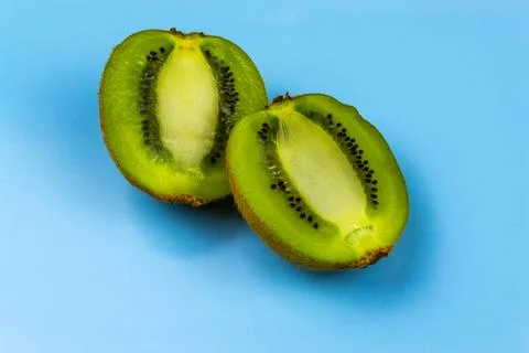 Kiwi on blue background Stock Photos