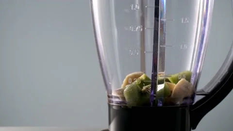 Kiwi chunks are thrown into blender to make smoothie. vegan drink for healthy Stock Footage 170441706
