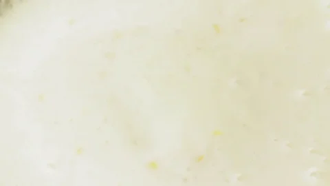Kiwi falling to yogurt full hd slow motion close up video. Fruit slice splashing Stock Footage 83937375