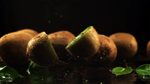 The kiwi falls and splits into two halves. Filmed is slow motion 1000 frames per Stock Footage 166609739