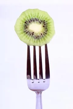 Kiwi on fork Stock Photos