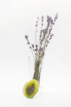 Kiwi in the form of an Easter egg cut in half, dried lavender in a glass Stock Photos