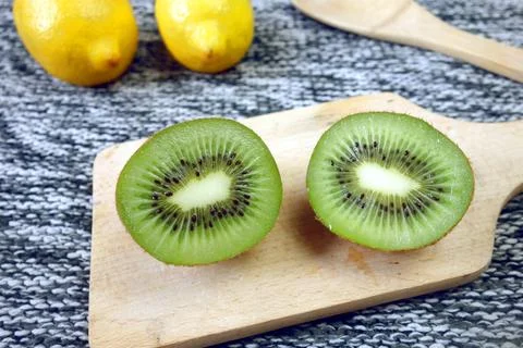Kiwi fruit on cutting board Stock Photos