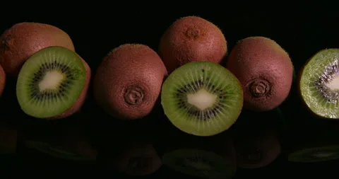 Kiwi Fruit Isolated in a studio on a glossy table Stock Footage 243265475