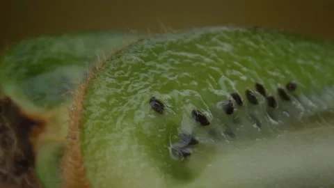 Kiwi fruit macro shooting,isolated half kiwi on yellow background rotates Stock Footage 131611717