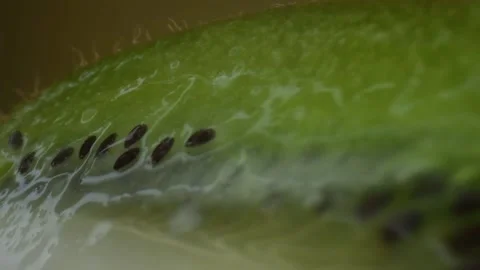 Kiwi fruit macro shooting,isolated half kiwi on yellow background rotates Stock Footage 131611833