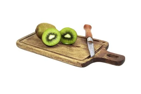 Kiwi fruit slice in cutting board have knife isolated on white background Stock Photos