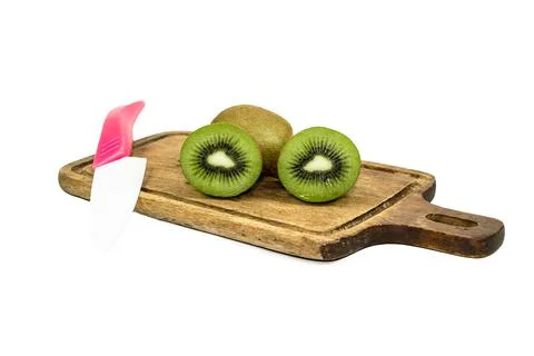 Kiwi fruit slice in cutting board have knife isolated on white background Stock Photos