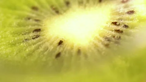 Kiwi Fruit Slice. Macro seeds. Fresh Green Kiwi in  sparkling water bubbles. Stock Footage 150567210