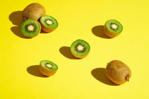 Kiwi fruits pattern on yellow background Stock Photos