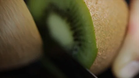 A Kiwi gets Halved with a Knife Extreme Closeup No. 2 Stock Footage 99163607