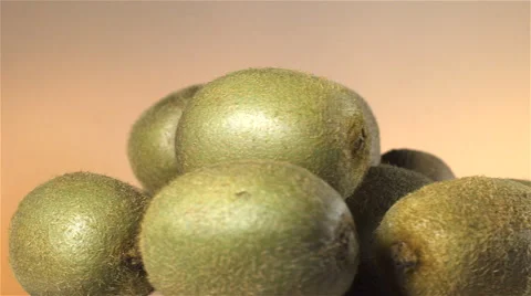 Kiwi isolated rotating on brown background. Stock Footage 63347318