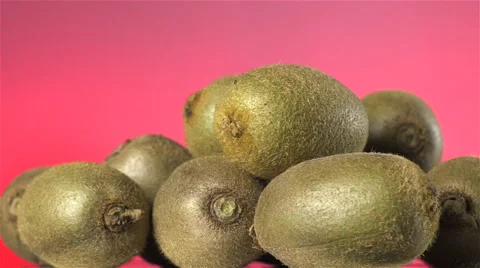 Kiwi isolated rotating on pink/red background. Stock Footage 63349250