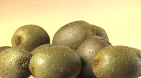 Kiwi isolated rotating on yellow background. Video stock 63349730