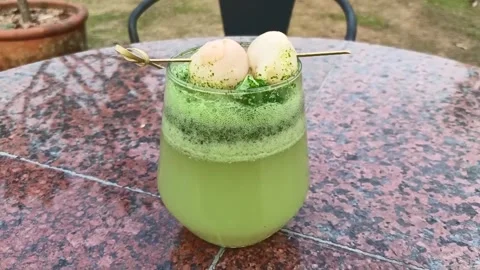 Kiwi juice topped with lychee fruit. Mix soda water with green kiwi puree Stock Footage 322600807