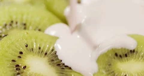 Kiwi pouring with Yogurt Stock Footage 124737978