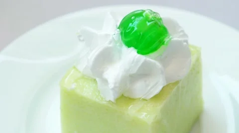 Kiwi pudding with green cherry on top Stock Footage 54227497
